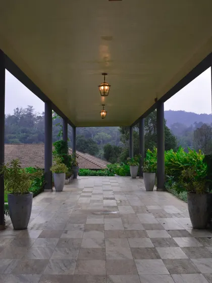 The serene, open-air corridors of a luxury resort in Coorg. I select venues that provide an atmosphere of calm and inspiration, perfect for strategic thinking and relaxation.