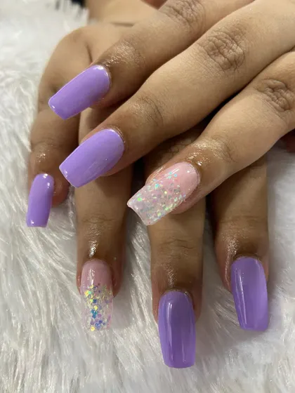 A lovely combination of lavender purple and chunky glitter. This shows how to balance solid colors with accent nails for a fun and stylish look.