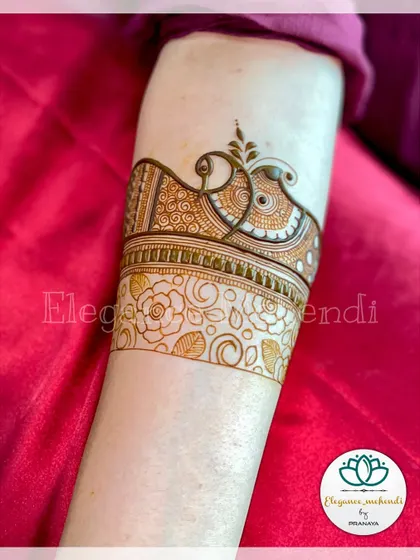 A startup design for an engagement mehendi, featuring a beautiful peacock motif on the arm.
