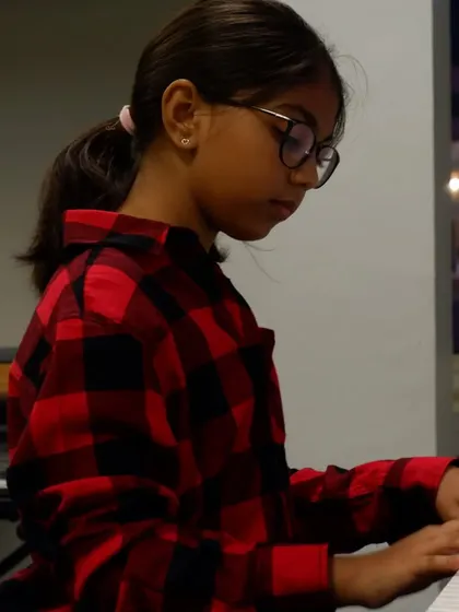 A student practicing her piano scales. The journey of a musician is built on these moments of quiet dedication.