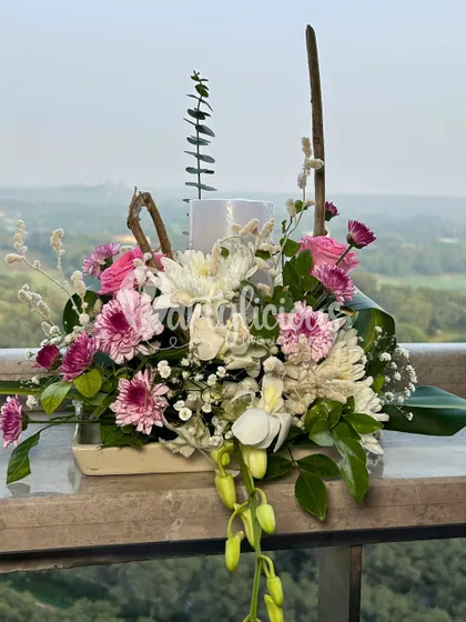 Turn any corner into a celebration. This beautiful floral arrangement with pink and white chrysanthemums is perfect for adding a touch of elegance to a side table or entryway.
