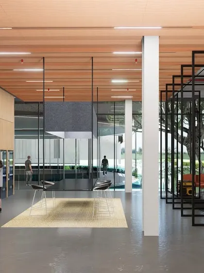 The interior of the ePositive campus features a grand atrium with a light wood staircase that doubles as tiered seating. This space is designed to foster collaboration and relaxation, with floor-to-ceiling windows and lush greenery creating a serene and inspiring environment.