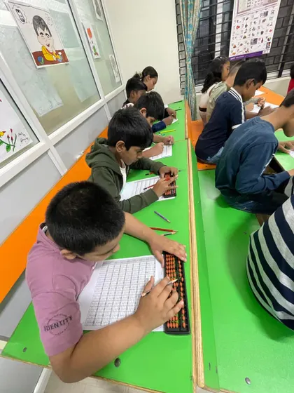 A student at our Bangalore center uses the abacus for calculations. We ensure all our centers are equipped with the right learning tools.
