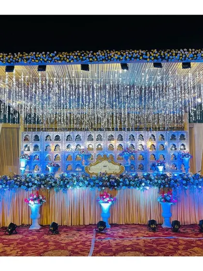 A grander version of the 'jharokha' stage, with a full canopy and dramatic lighting. This setup is designed to make a huge impact in a large banquet hall.