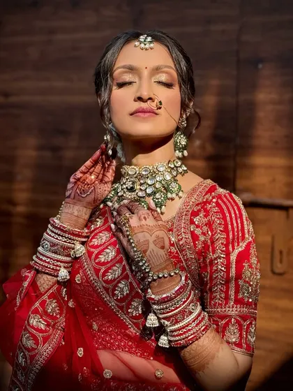 This artistic shot captures the bride's glowing skin and the intricate details of her henna and jewelry.