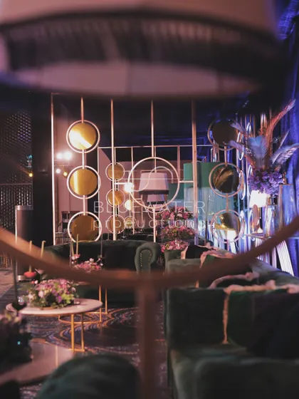 A creative partition for the lounge area, using gold frames and tinted mirrors to create a stylish and modern screen.