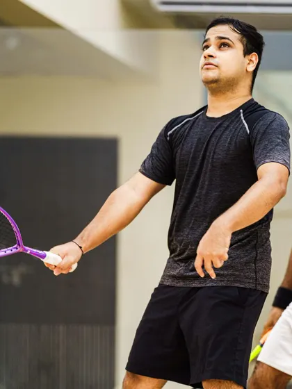 A candid moment between points. Yash Salunkhe looks up, tracking the ball's trajectory. These in-between moments are crucial for telling the complete story of an athlete's performance.
