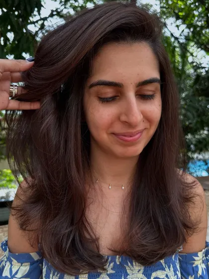 A happy client after her color refresh and haircut. The new layers frame her face beautifully.