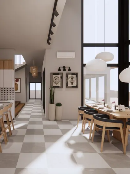 The checkerboard floor in this Goa holiday home adds a touch of classic, graphic appeal. It grounds the open, airy dining space and kitchen, which features soaring ceilings and sculptural pendant lights.