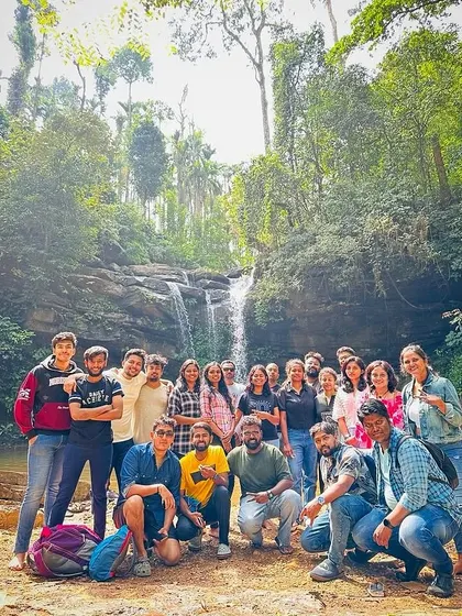 The New Year's batch posing together in front of a waterfall.