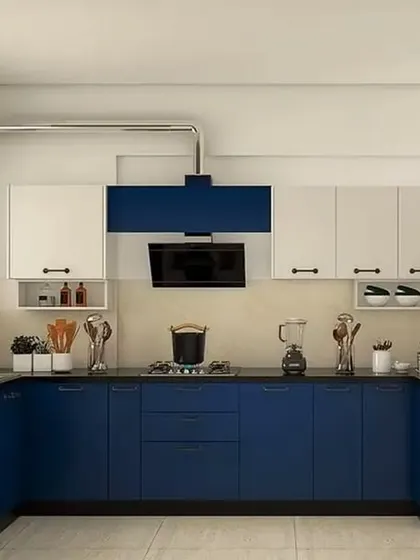 This U-shaped kitchen uses a bold blue for the lower cabinets, contrasted with clean white uppers. This two-tone approach adds personality while keeping the space feeling bright.