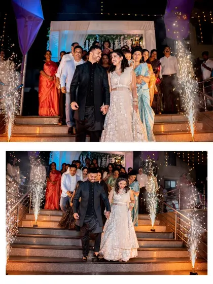 A grand entrance down a staircase lined with sparklers, a truly cinematic moment from an engagement party.