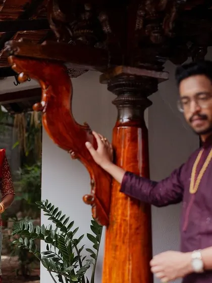 A couple shares a look, framed by the unique wooden pillars of our architecture.