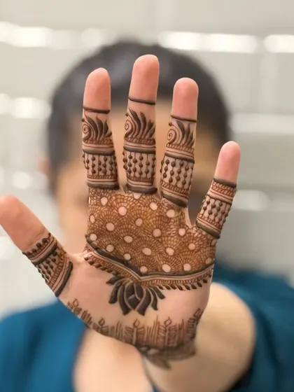 A candid shot of a simple and chic back of hand design. The dotted pattern on the palm and the delicate finger details are perfect for a minimalist look.