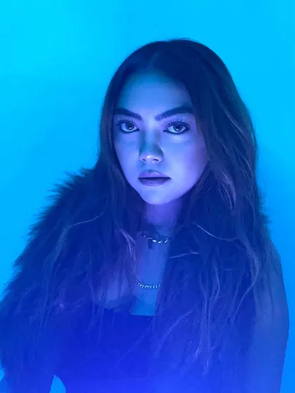 A striking portrait with intense blue lighting, creating a moody and artistic feel.