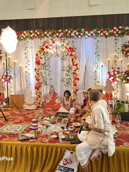A religious ceremony (puja) taking place on a stage I decorated. The setup is both beautiful for the event and functional for the rituals.