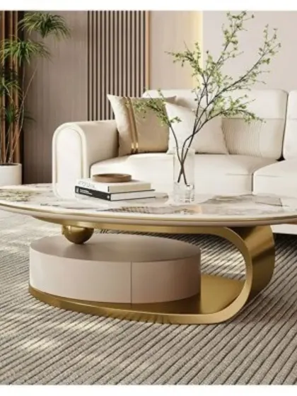 A close-up of the oval center table with a gold-finished base and integrated storage. This piece is perfect for adding a touch of sophistication to a contemporary living room.