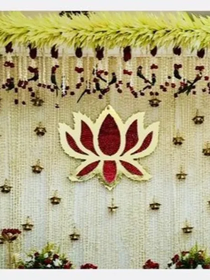 A beautiful backdrop of tuberose strings with a central lotus motif and hanging diyas, perfect for a traditional ceremony.