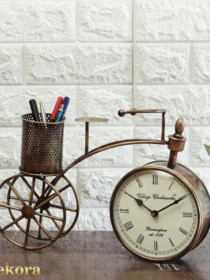 A similar metal cycle table clock, this version includes a pen holder, adding extra utility. It's a practical and decorative gift for an employee's desk.