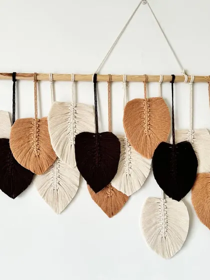 The layered leaves in this wall hanging create a sense of movement and depth.