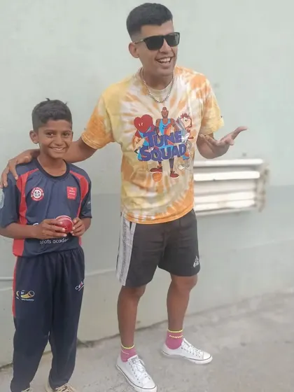 A coach and a young player share a fun moment after a successful match, highlighting the positive and encouraging relationships we build.