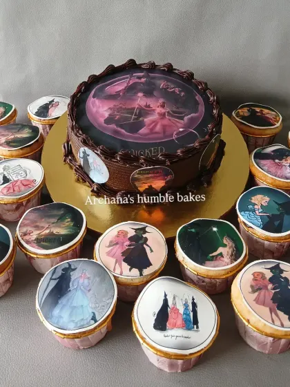 A cake and matching cupcakes based on the Broadway show "Wicked the Musical," with edible images from the play.