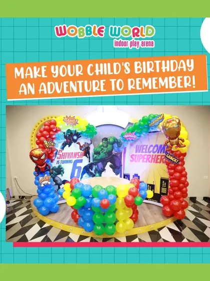 A wide shot of our superhero party decor. The "Welcome Superheroes" sign, character cutouts, and colorful balloon columns set the stage for an adventurous day.