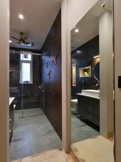 A view from the doorway, showing the cohesive design of the washroom and its connection to the wardrobe area.