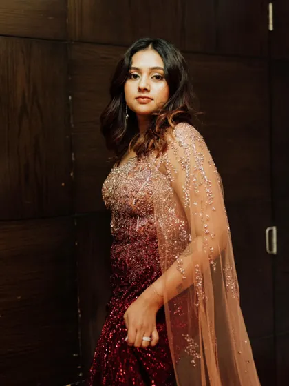 The ombre sequin gown is complemented by a soft glam makeup look, with a focus on radiant skin and defined eyes.
