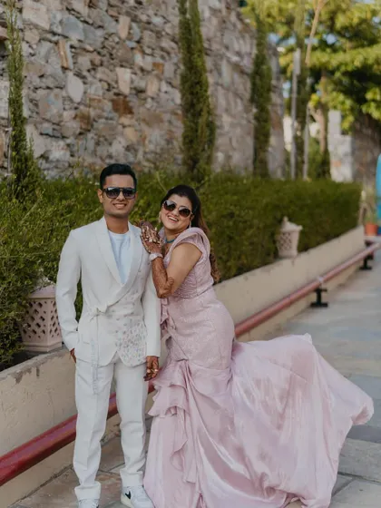 A stylish portrait of the couple at their wedding carnival. Their coordinated outfits and cool sunglasses give them a chic and modern look.