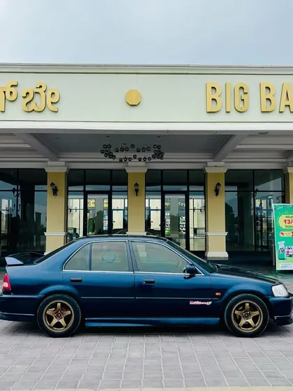 A classic sedan parked in front of our main entrance, ready for a weekend getaway. We're the perfect pitstop to relax and recharge.
