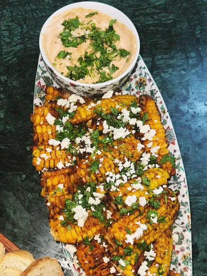 Our take on Mexican street corn, served as Elote Ribs. The corn is grilled and seasoned, then topped with feta cheese and fresh cilantro, served with a zesty dip.