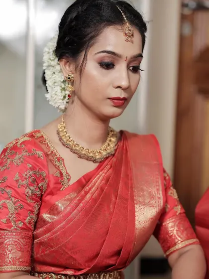 A close-up shot focusing on her classic makeup with a bold red lip.