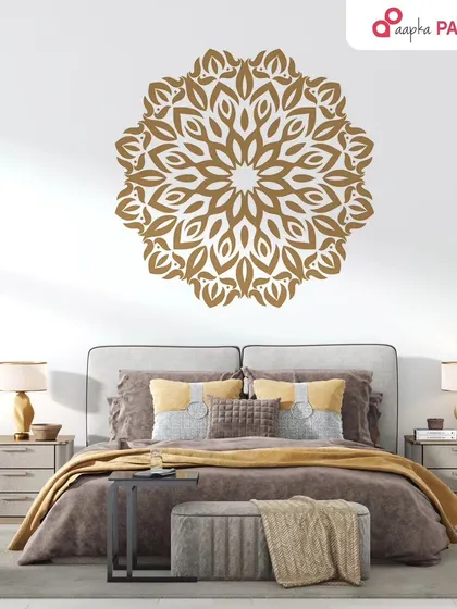 A stunning golden mandala painted above the bed serves as a beautiful and spiritual centerpiece for this bedroom, promoting a sense of harmony and peace.