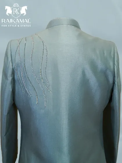 The back of the pastel green jacket, showing the subtle, wave-like embroidery that adds a touch of modern elegance.
