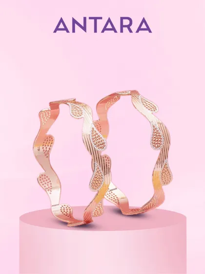 This is not just a pair of bangles, but poetry in gold. Intricately etched paisley motifs dance across the matte gold surface, creating depth and dimension that showcase true artistry.