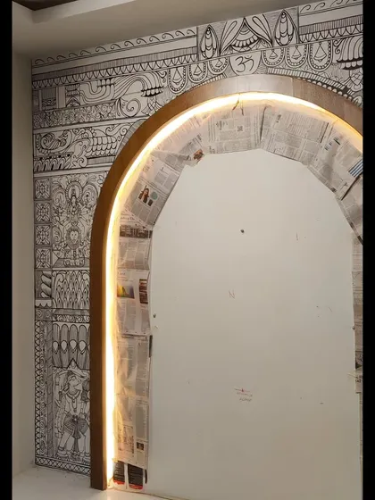 The archway with integrated lighting, which beautifully highlights the detailed line work of the mural.
