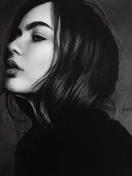 A dramatic and moody portrait in charcoal by Ayush Agnihotri. The deep blacks and subtle highlights create a sense of depth and mystery, demonstrating the expressive power of the medium.