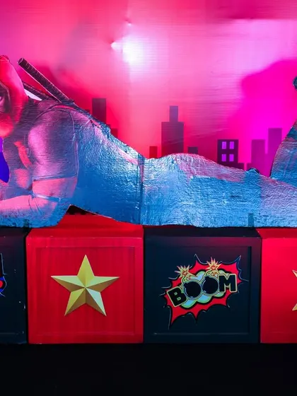 A close-up of the incredible 3D-printed, life-sized Deadpool prop in his iconic reclining pose.