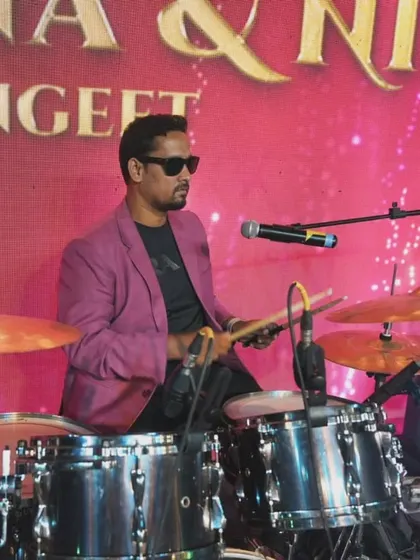 Our drummer keeping the beat alive at a Sangeet party. A strong rhythm is the heart of a packed dance floor, and we make sure the energy never drops.