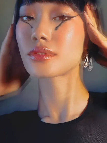 Letting the eyes do all the talking. This creative editorial look features a graphic winged liner with delicate dot details for an artistic touch.