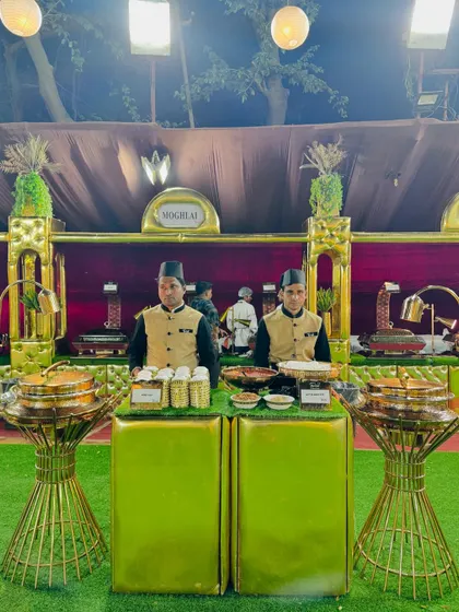 Two chefs at the ready behind the Mughlai food counter, ensuring prompt and professional service.