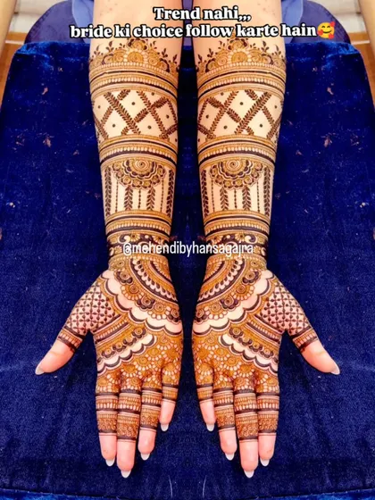 My philosophy is simple: I follow my bride's choice, not trends. This design is for the bride who loves elegance, with clean, symmetrical patterns on the arms and open palms for a look that is both royal and understated.
