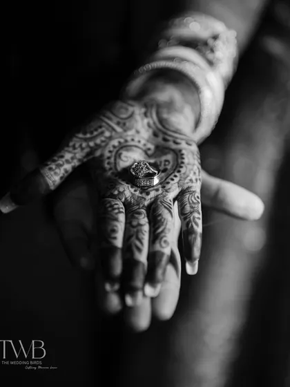 It's the little things that tell the biggest stories. This shot focuses on the union of two hands, the intricate mehndi, and the wedding ring that seals their promise. We believe these details are the beautiful footnotes in your love story.