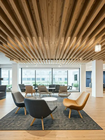 This beautiful office lounge with a wooden slat ceiling is an example of how parametric principles can be applied to create visually stunning and acoustically effective spaces.