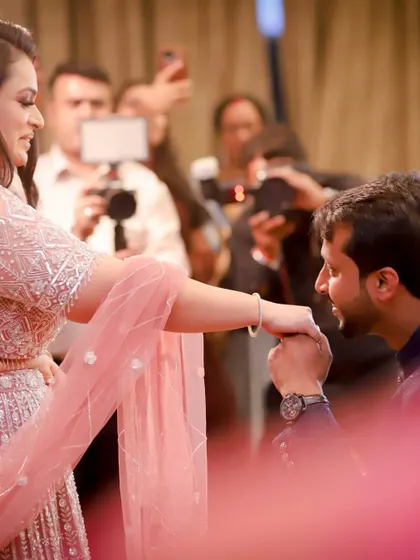 The classic proposal moment during an engagement ceremony. He gets down on one knee to kiss her hand, a timeless gesture of love and commitment that I love to capture.