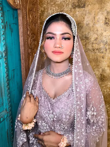 The full look, with the dupatta draped gracefully over her head.