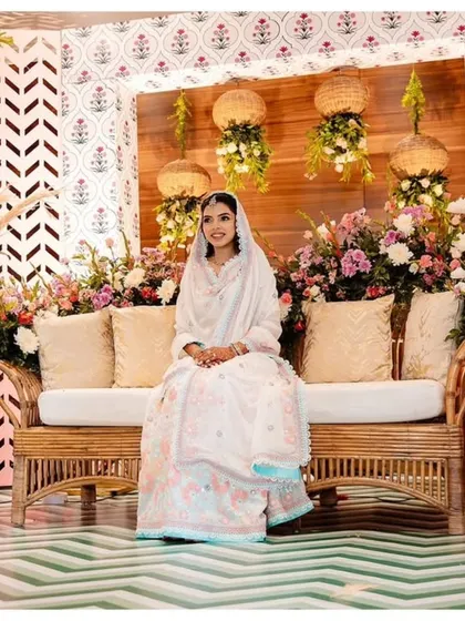 This Mehendi seating features a comfortable cane sofa set against a mixed-pattern backdrop. I used hanging floral baskets and soft cushions to create a relaxed yet stylish atmosphere.