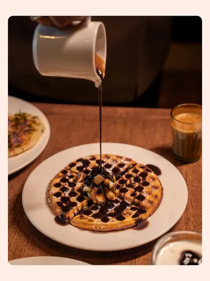The final result of a chocolate-drenched waffle. This image focuses on the finished product, looking glossy and ready to eat.