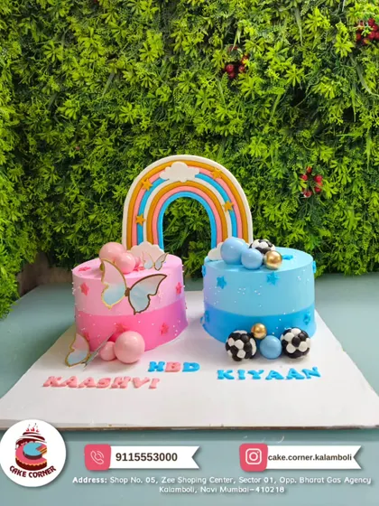 A unique two-in-one cake for Kaashvi and Kiyaan. One side is a pink butterfly theme, the other is a blue football theme, united by a rainbow. Perfect for a joint birthday party.